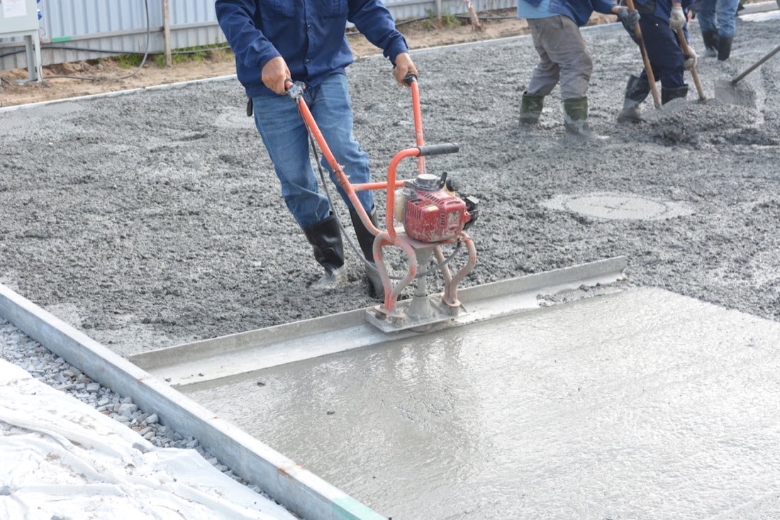 Concrete crew finishing a fresh slab in Northern Colorado